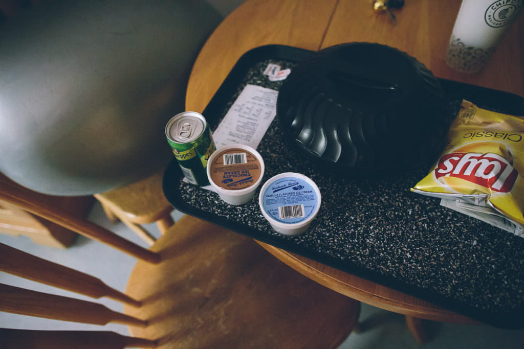 hospital tray of old food sitting on a table