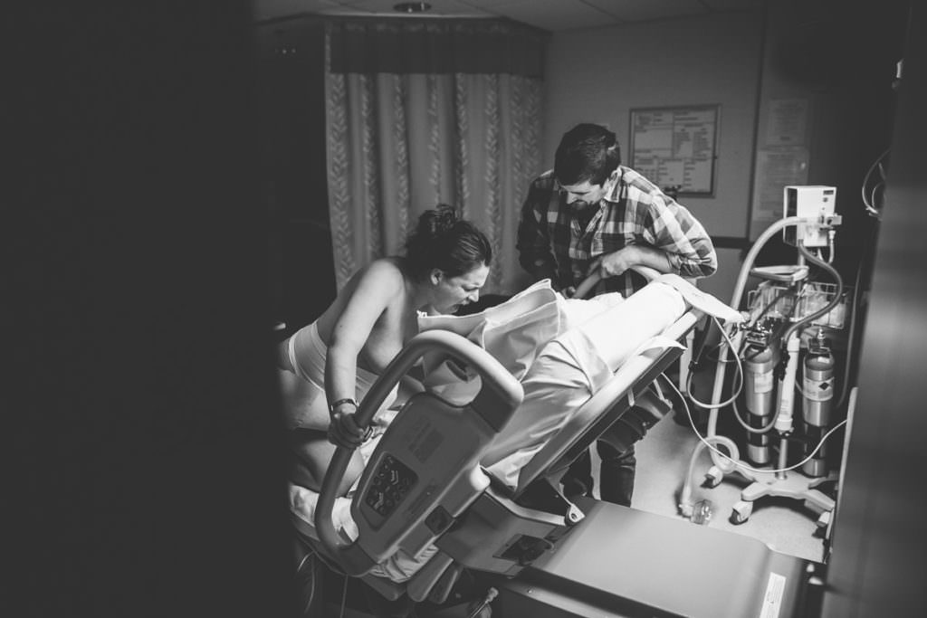 mom laboring and screaming on her hands and knees during a contraction with husband cheering her on at Burdette Birth Center in Troy NY