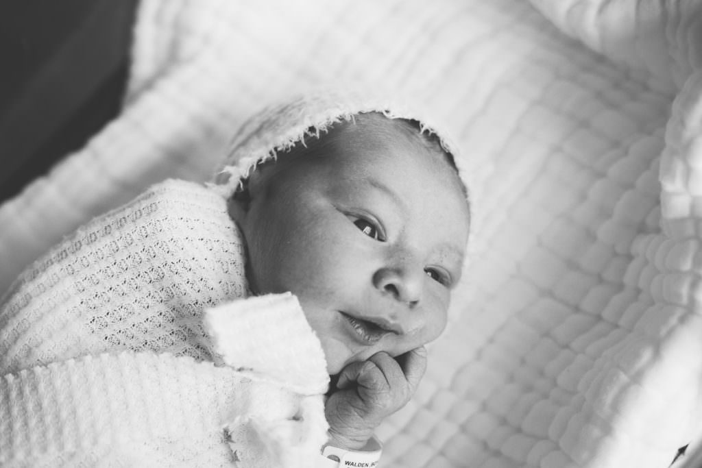 fresh 48 session where baby is wearing white hand and putting hand in mouth