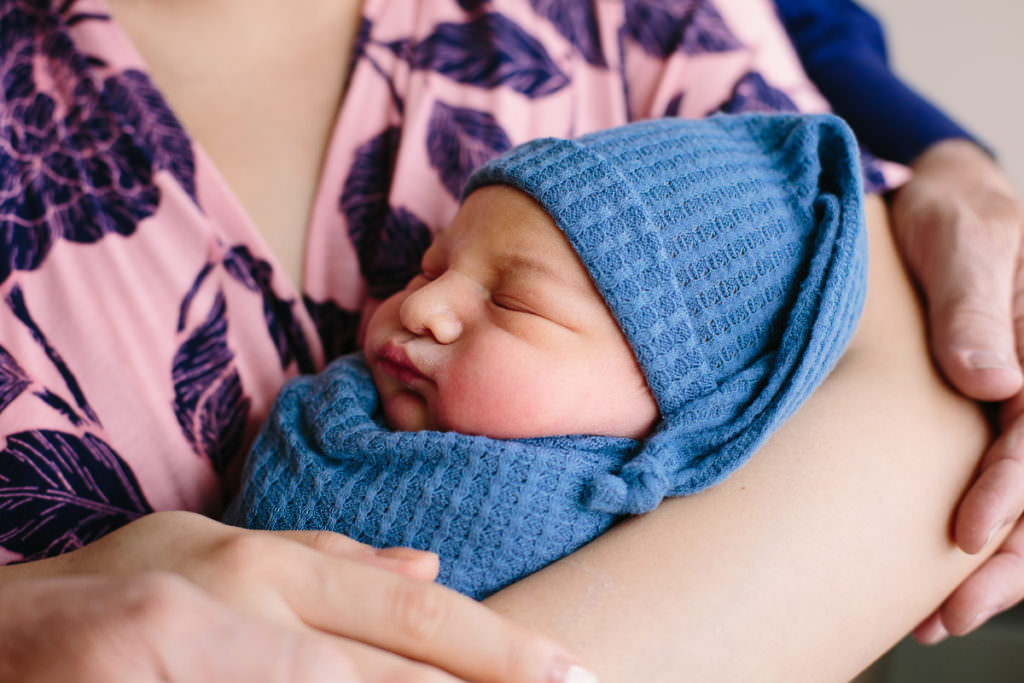 sleeping baby snuggled close to mom during fresh 48 session