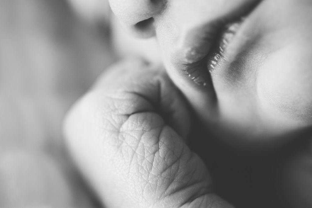 close up of newborn baby wrinkle hands