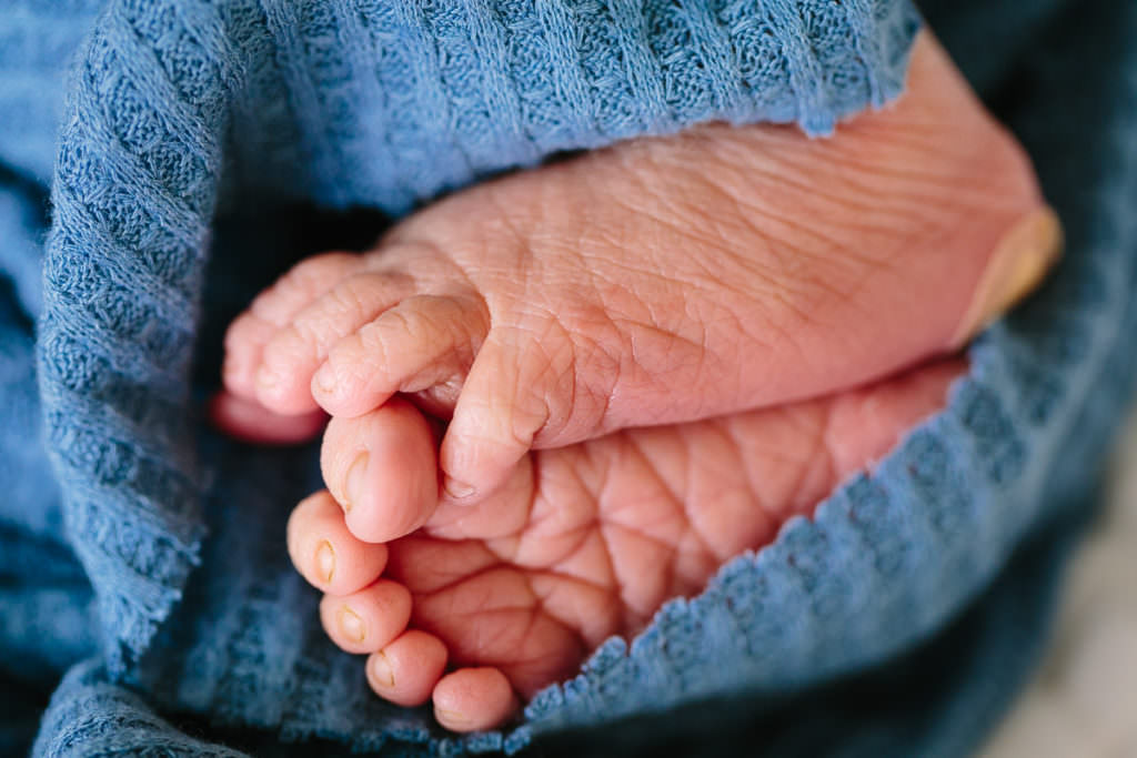 close up of baby just born with wrinkley feet