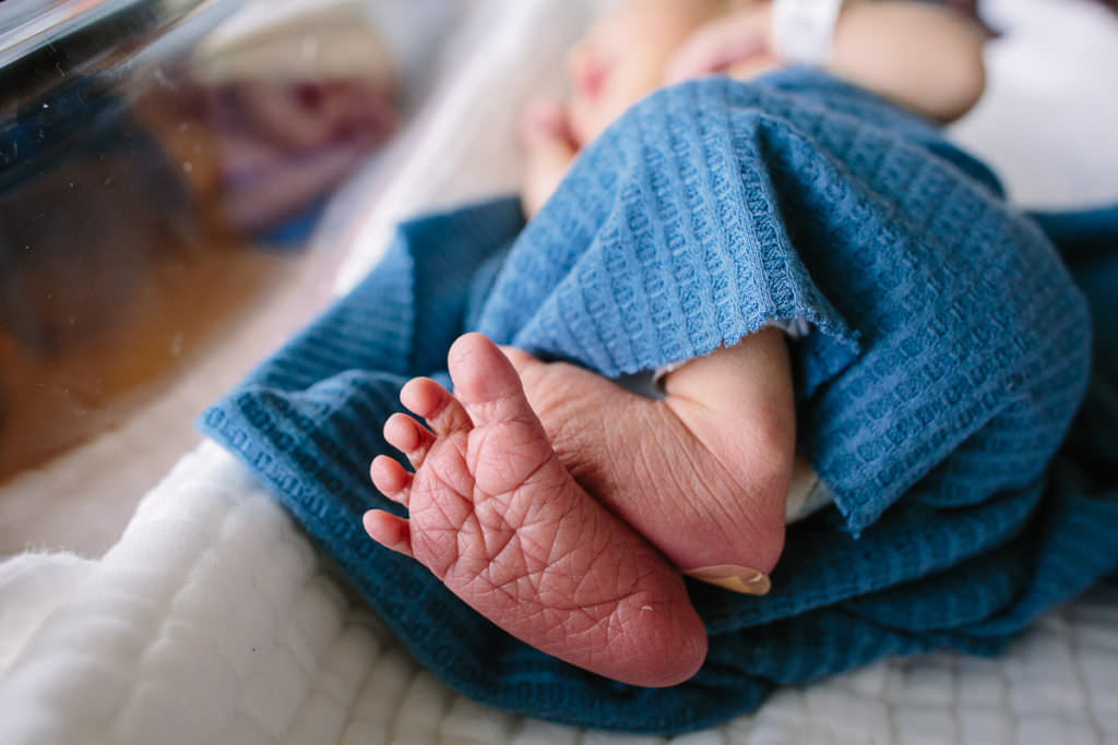 baby feet wrapped in a blue blanket