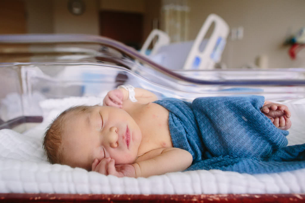 baby boy laying in hospital bassinet