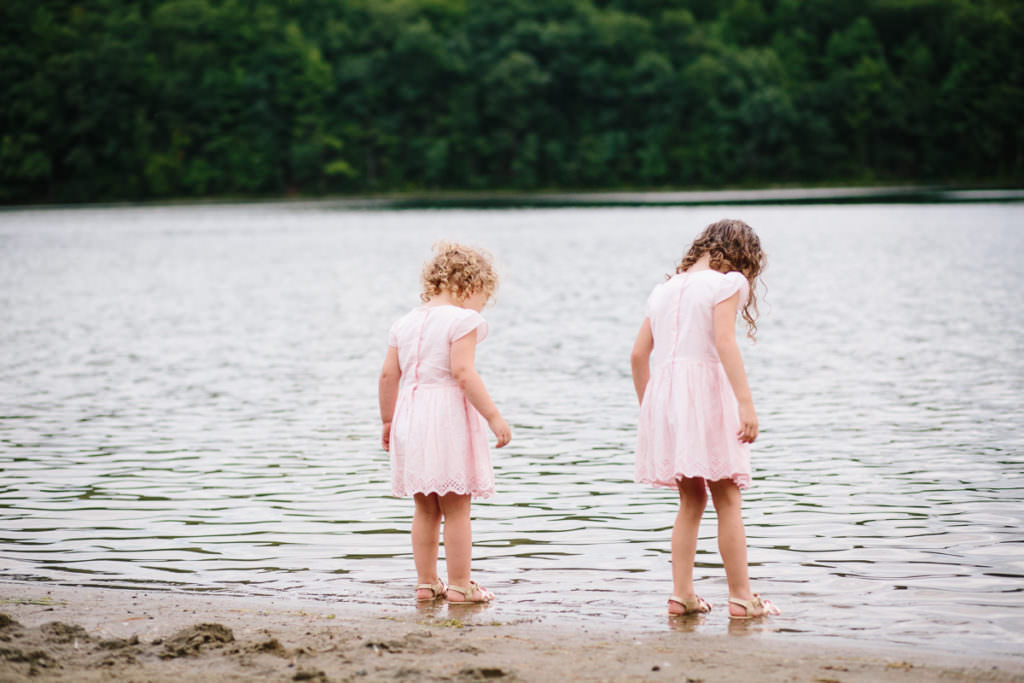 sisters wadding in the water of moreau lake