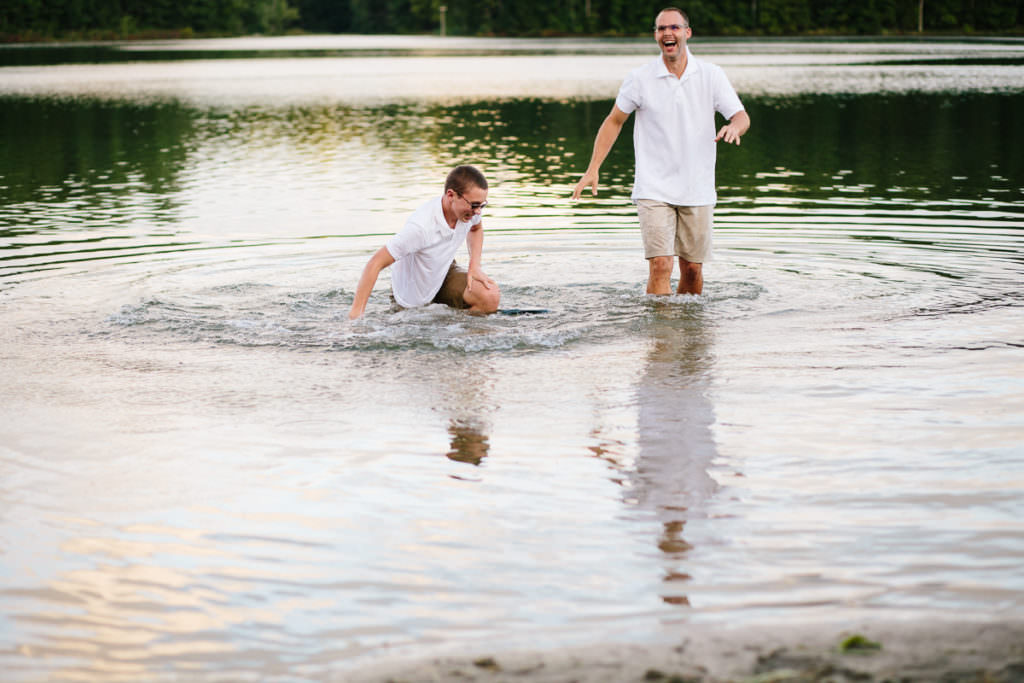 teenage boy falls into to water after dad drops in fully clothed