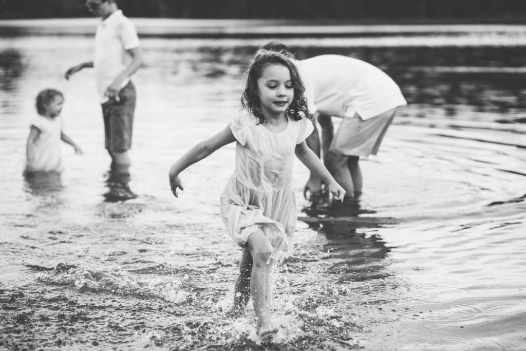 little girl in dress runs through moreau lake