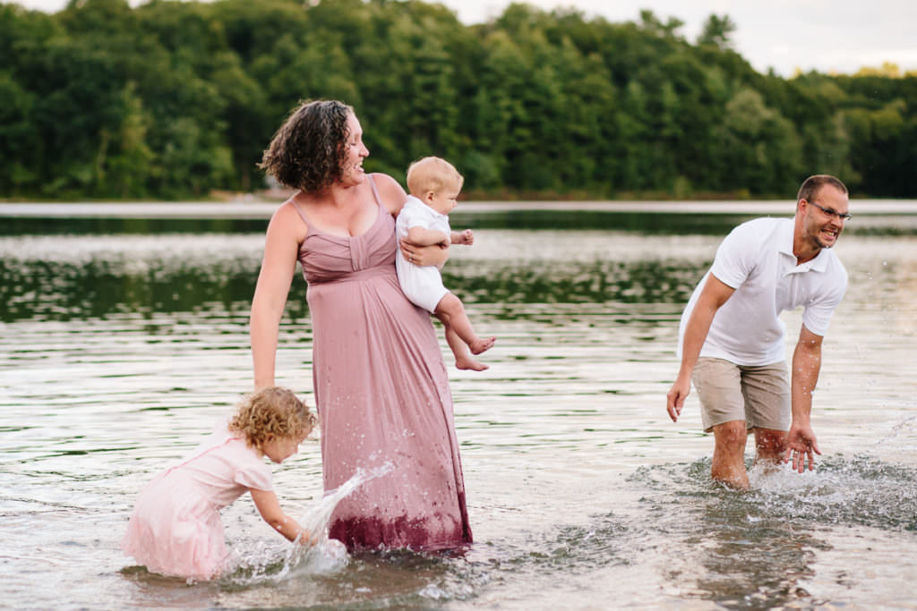 mom and kids playing in a lake fully clothed