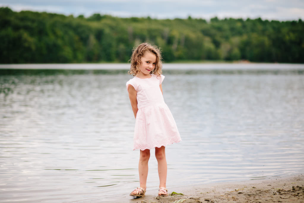 little girl with pink dress and brown hair at moreau lake
