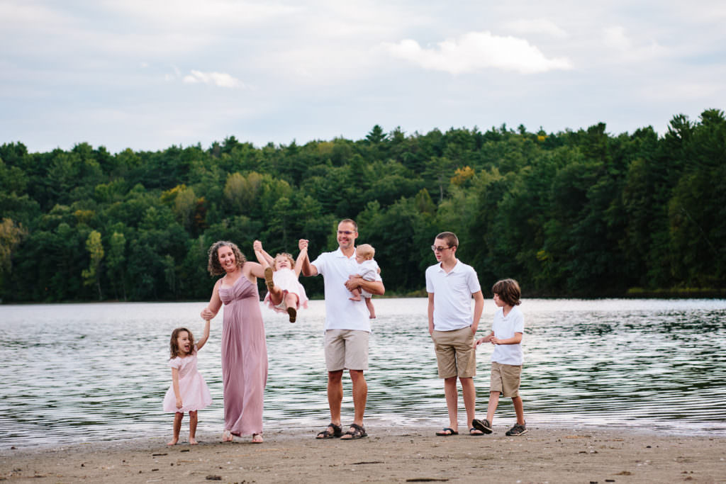 Family swinging their toddler at moreau lake