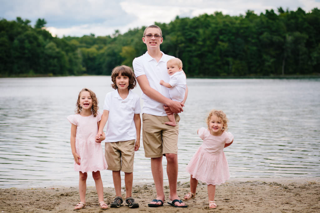 five siblings standing at the beach at moreau lake