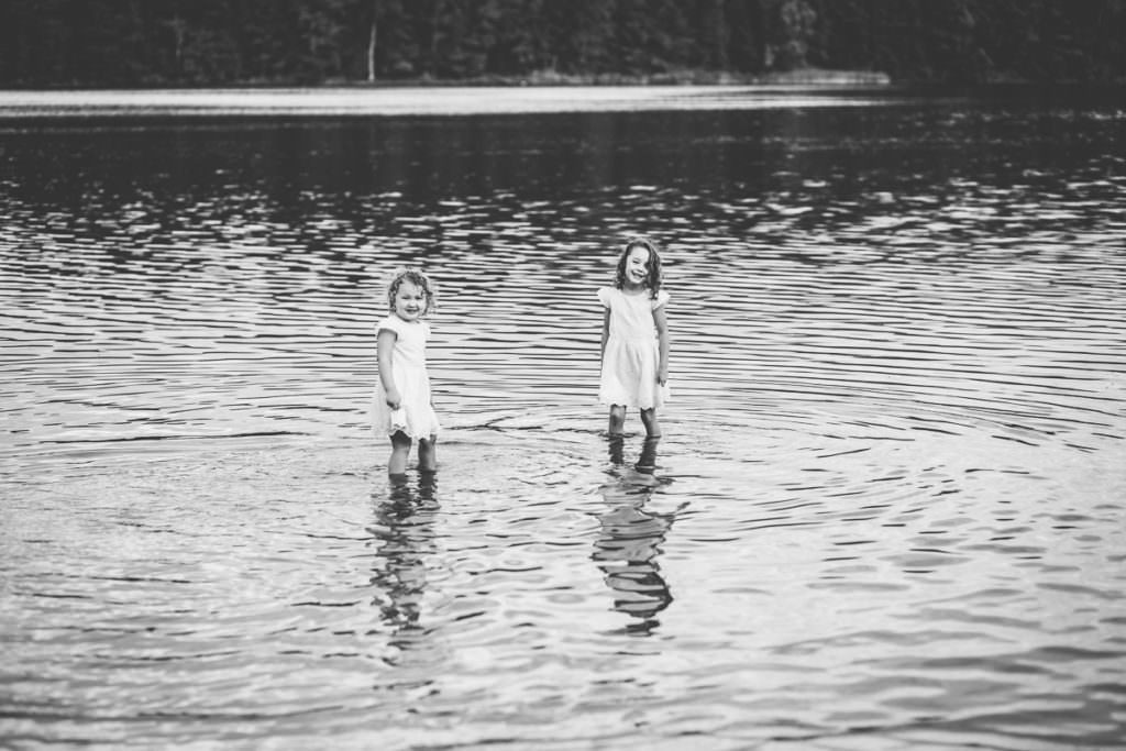 two little girls wadding in the lake at moreau lake state park new york