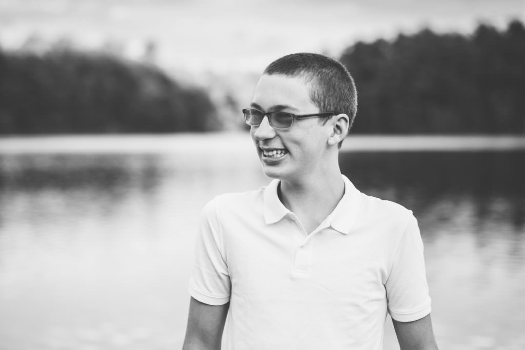 teenage boy with transition glasses with moreau lake in the background