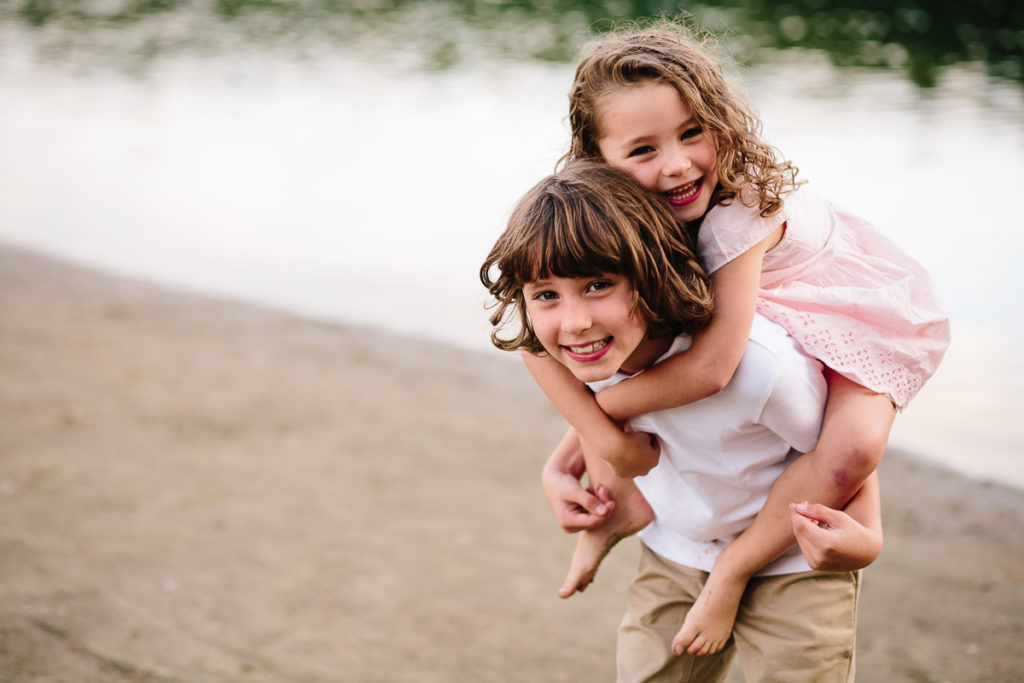 young boy giving his little sister a piggy back ride