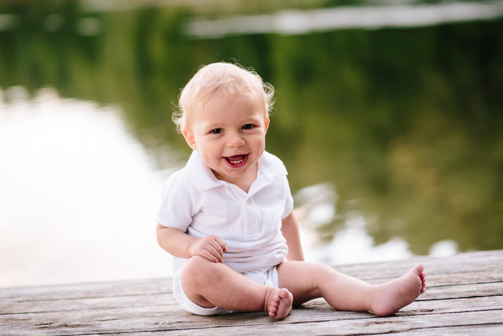 baby boy sits on picnic bench at new york state park