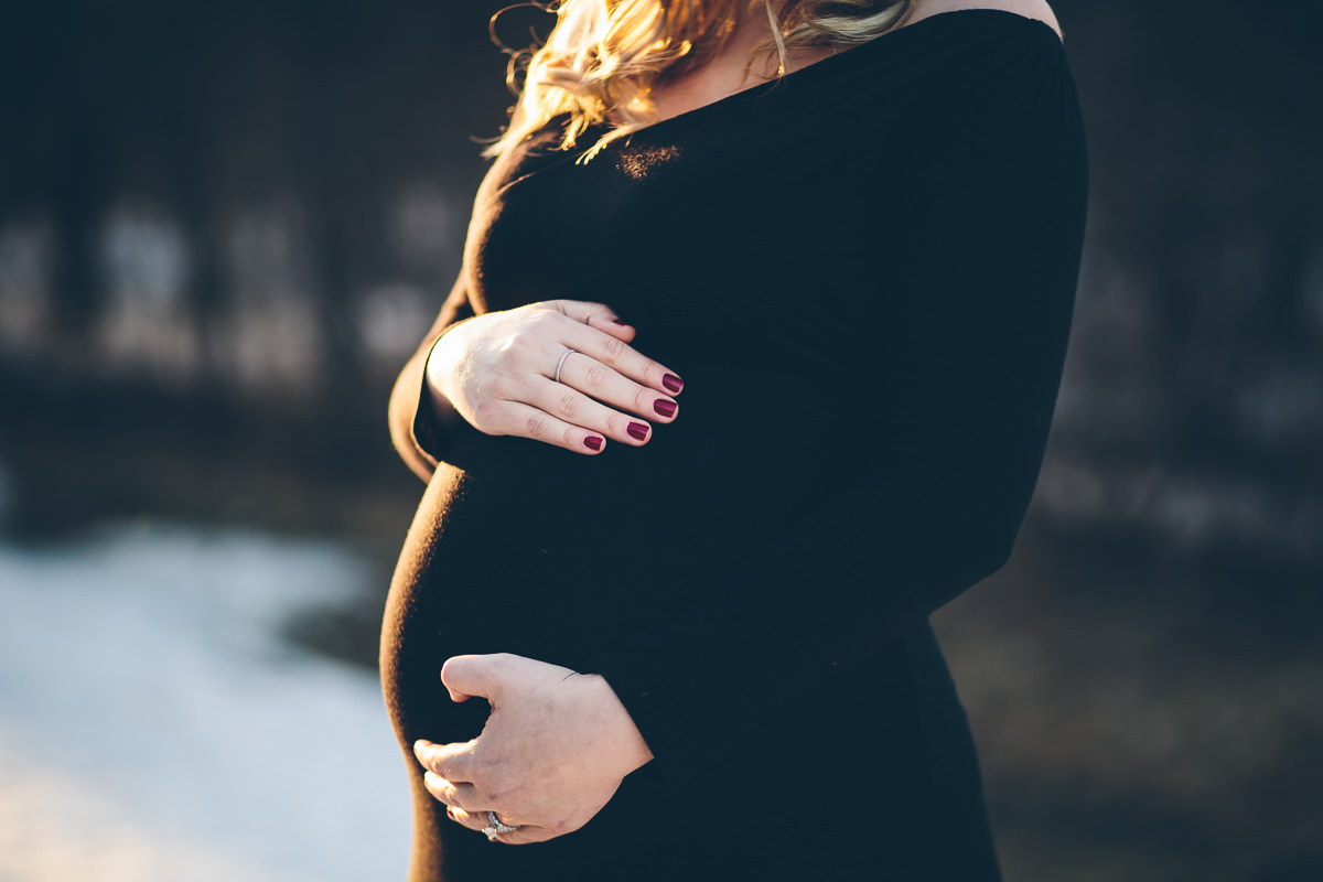 Saratoga NY Maternity Photographer mom holding pregnant belly
