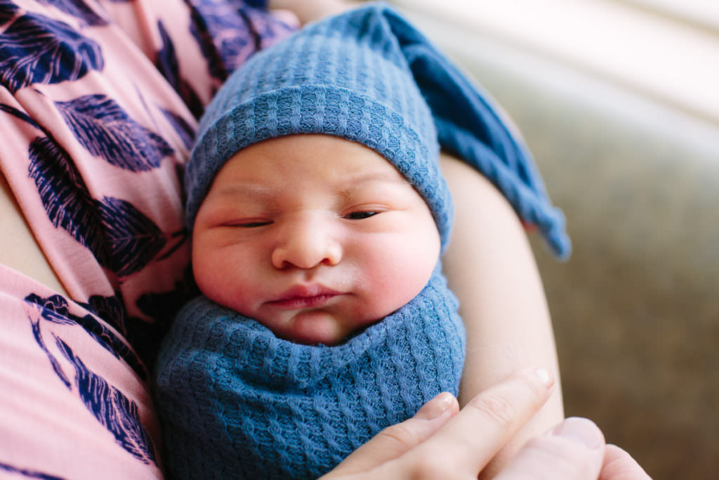baby boy in blue hat and swaddle Albany New York birth photographer