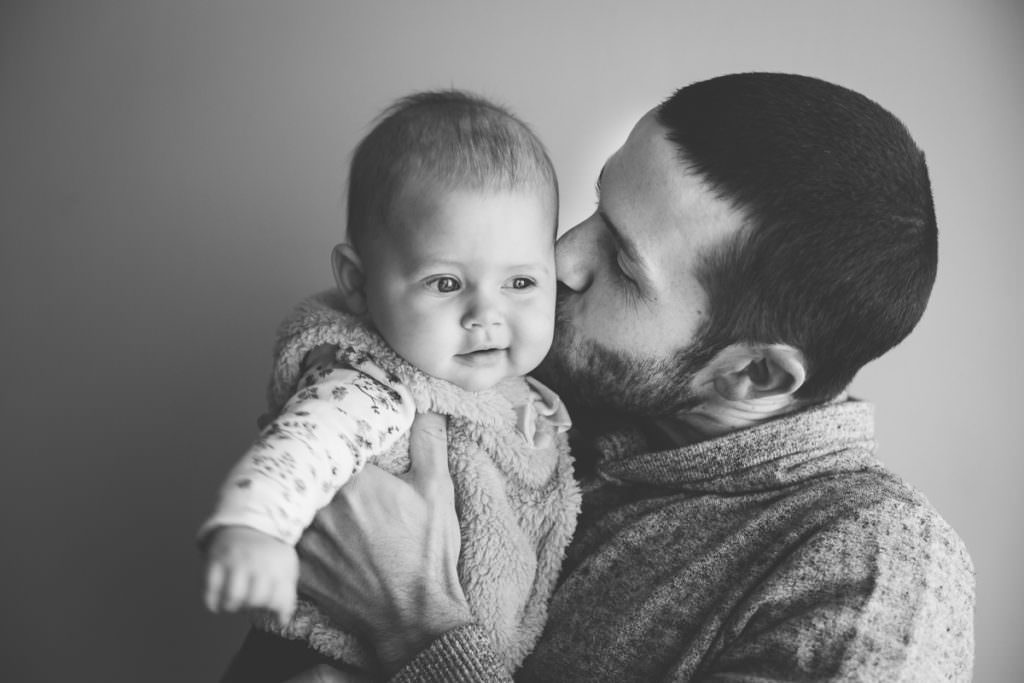 dad kissing baby cheek lifestyle home session Saratoga NY