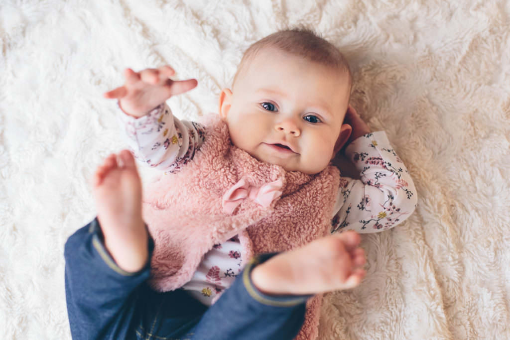 baby girl grabbing toes Clifton park NY baby photography
