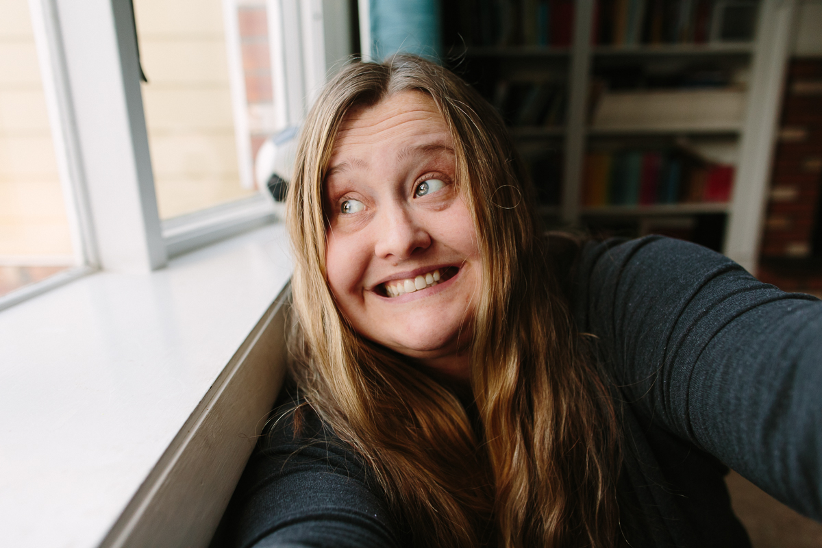 Albany New York Birth Photographer April Newman looking out a window