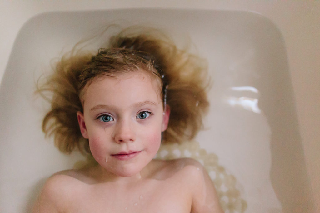 little girl lying in bath ny lifestyle photographer