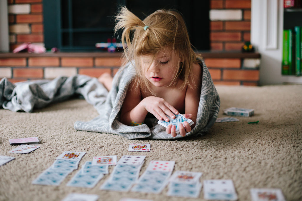 learning how to play solitaire young girl