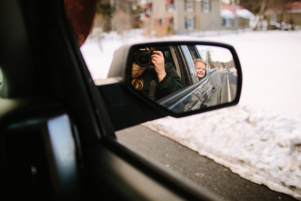 child sticking head out of window like a puppy