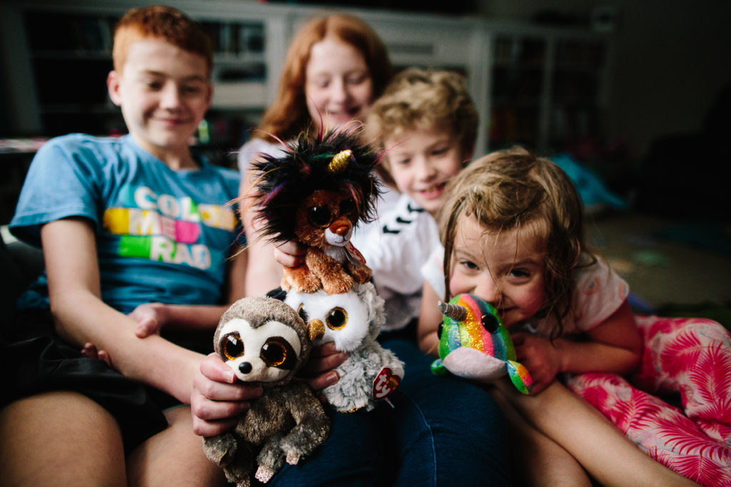 siblings snuggle on the couch Clifton Park NY family photographer