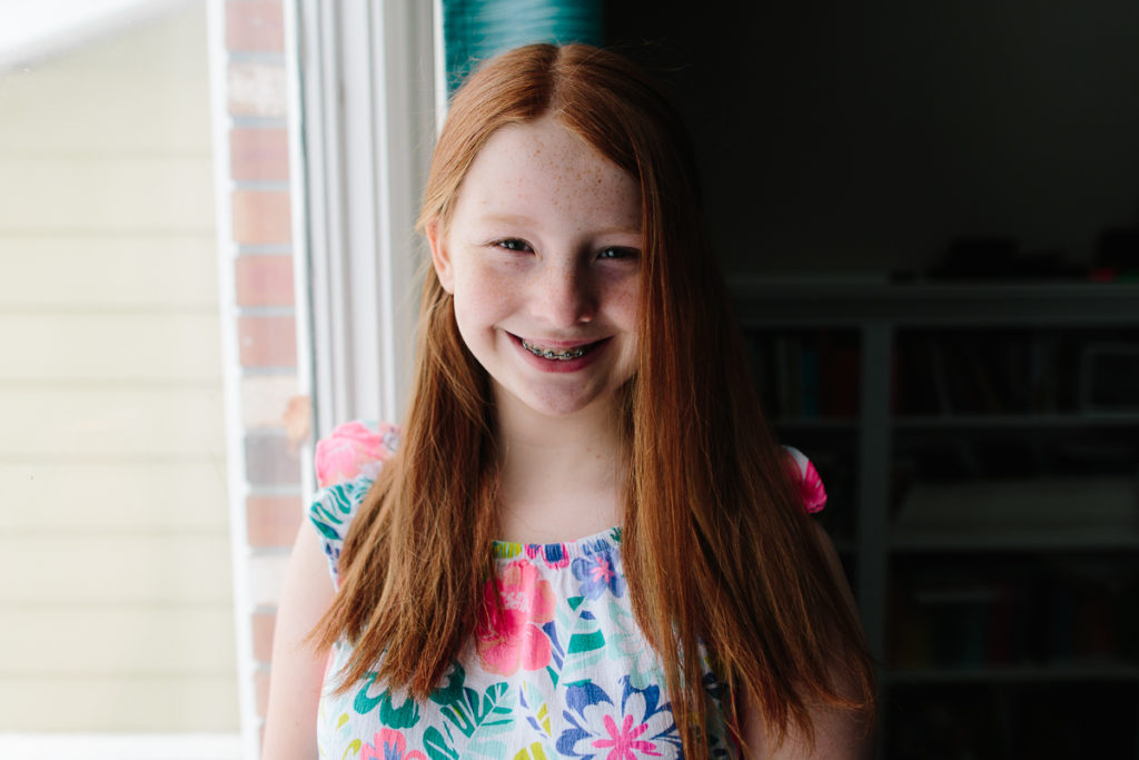 red hair girl by window Albany NY portrait photographer