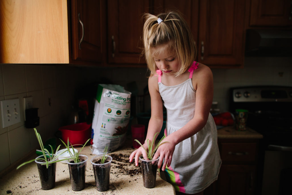 little girl planting plants child photographer