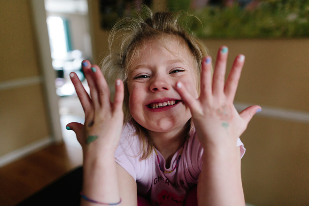 little girl with painted finger nails