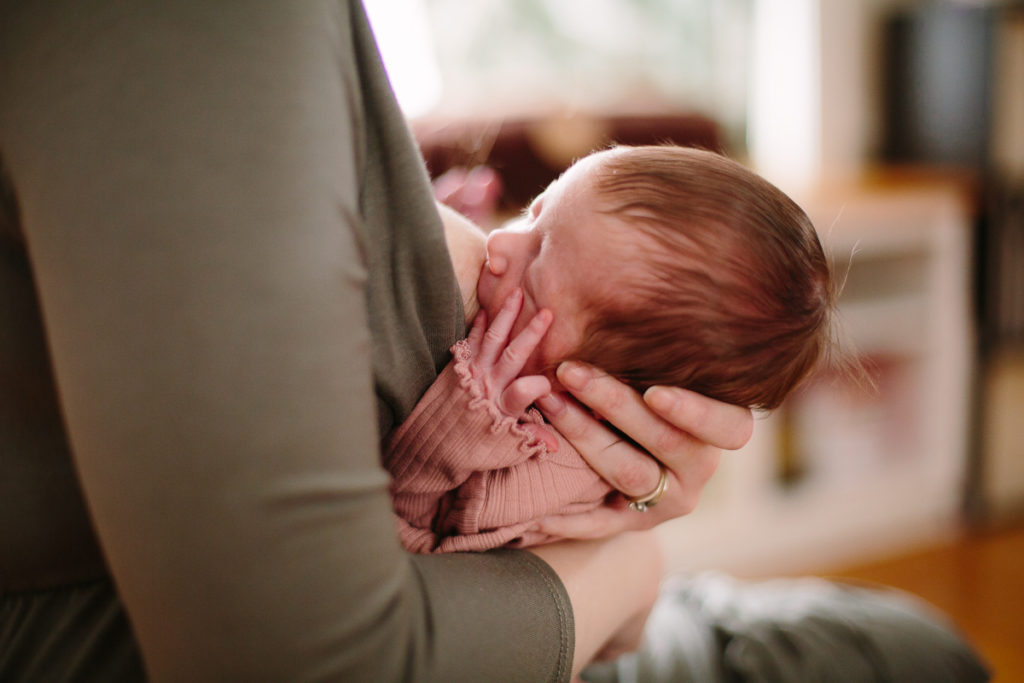newborn baby girl breastfeeding