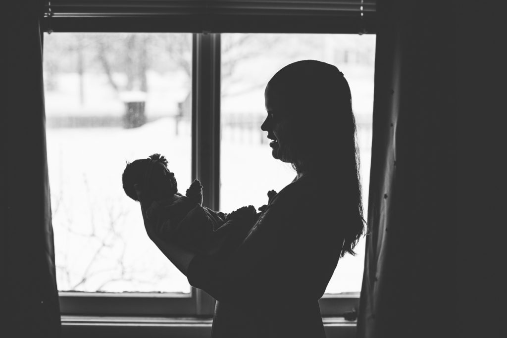 mom holding baby silhouette