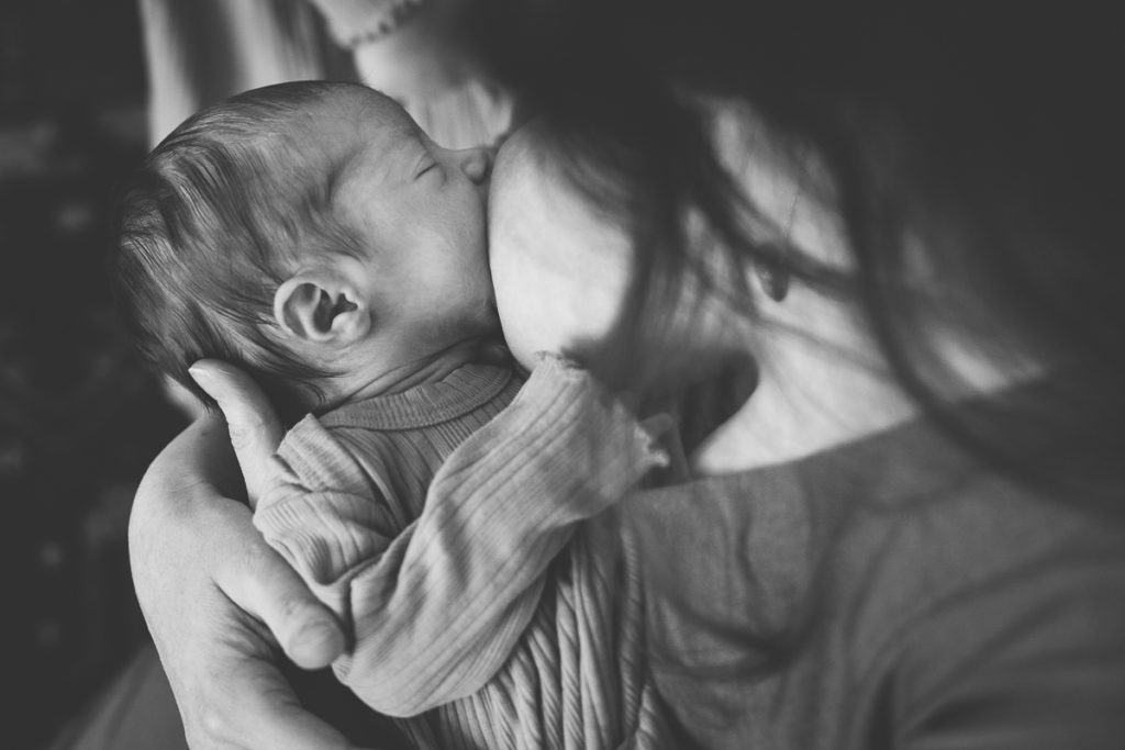 newborn baby girl breastfeeding