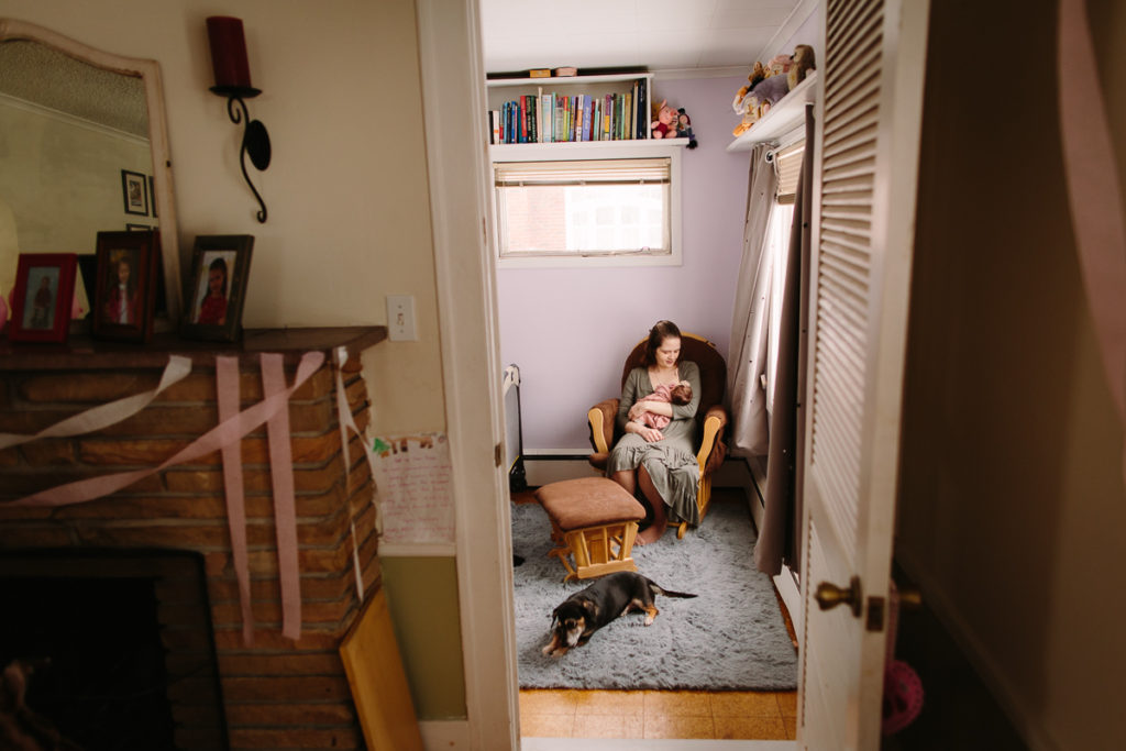 mom breastfeeding during lifestyle newborn session Albany NY