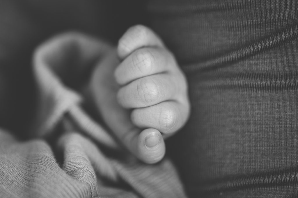 black and white picture of newborn baby hand