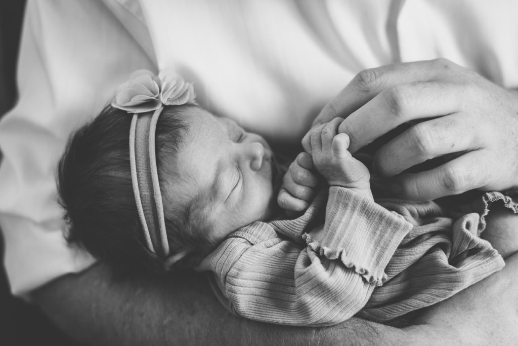 dad holding newborn baby girl