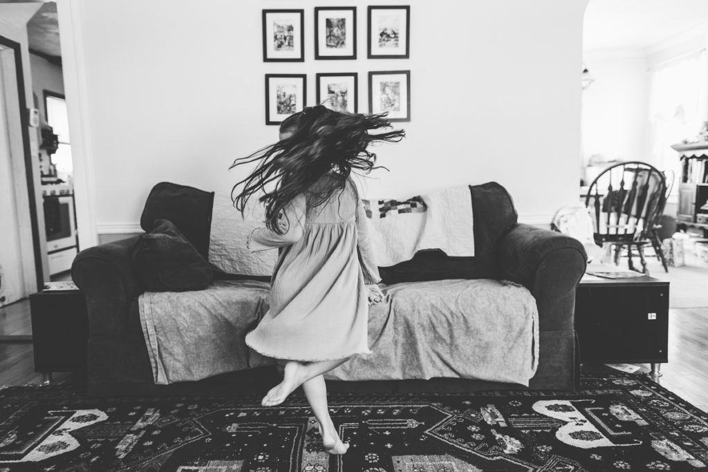 little girl spins in air during lifestyle family session latham NY