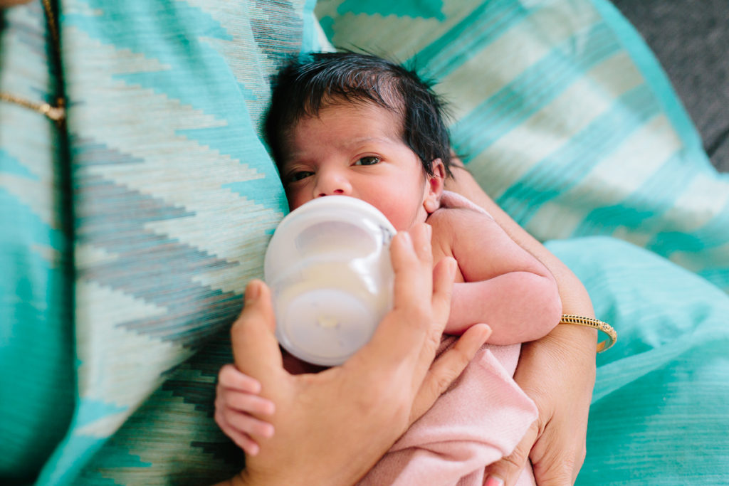 baby getting bottle during her lifestyle newborn session