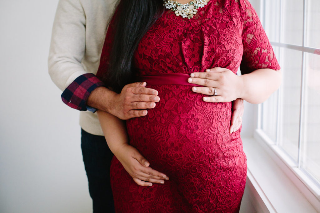 husband and wife holding pregnant belly Clifton Park NY