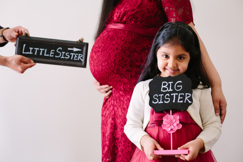 Big sister and little sister signs maternity photographer
