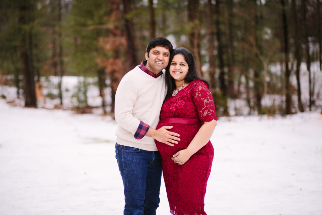 husband and wife in the snow during maternity photoshooot