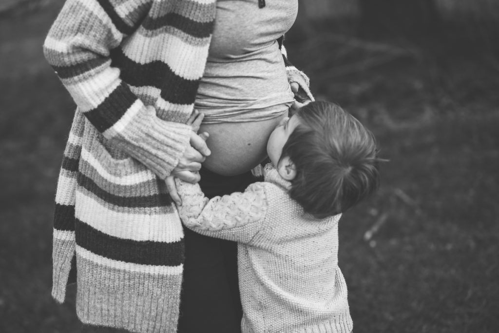toddler kisses mom's belly Halfmoon NY Maternity photographer