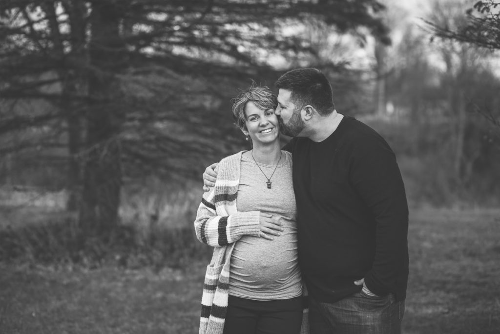 Halfmoon NY Maternity Photographer dad kissing mom cheek