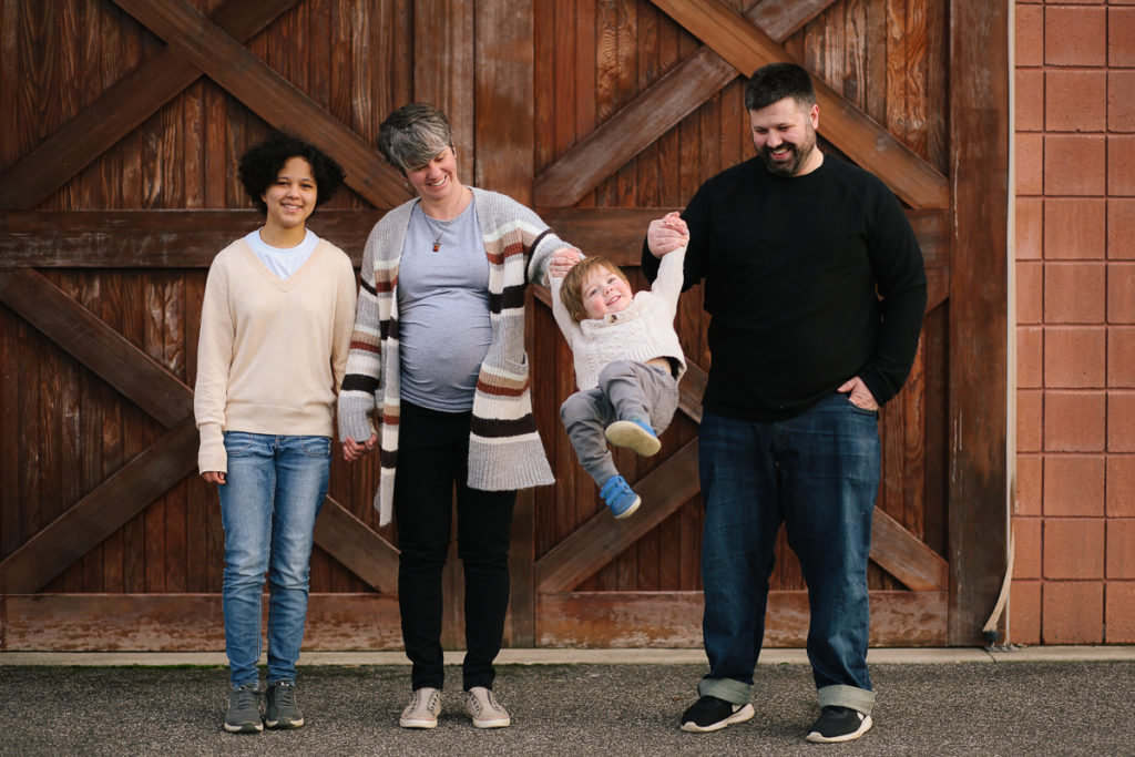 family portrait family swinging toddler