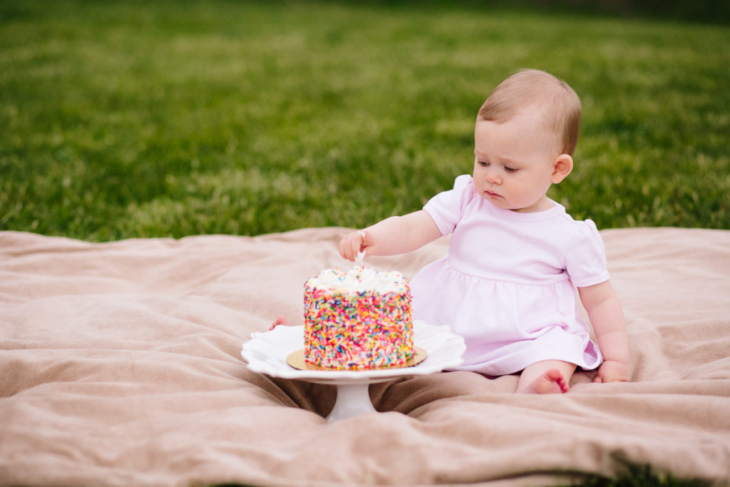 baby not sure about cake smash