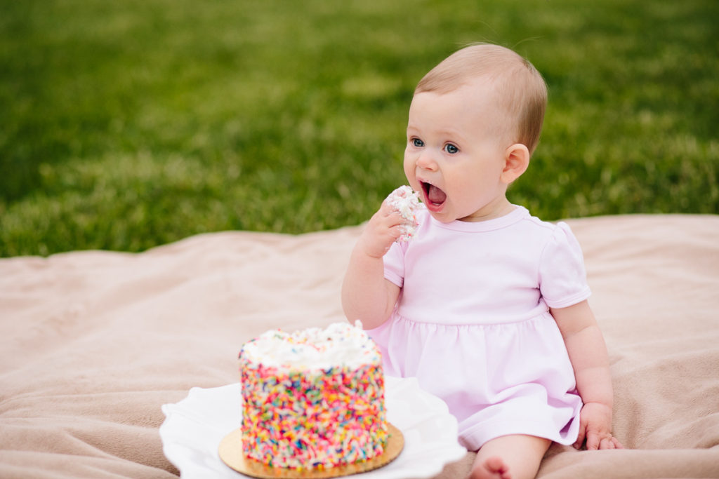 trying a bite of cake during cake smash photography