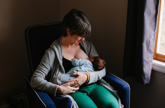 mom breastfeeding newborn baby boy