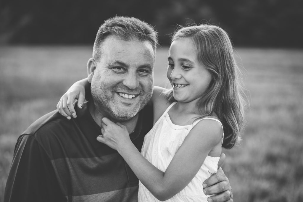daughter tickling dad black and white portrait