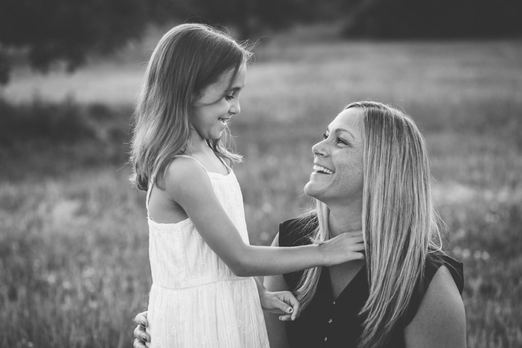 mom and daughter smiling at each other